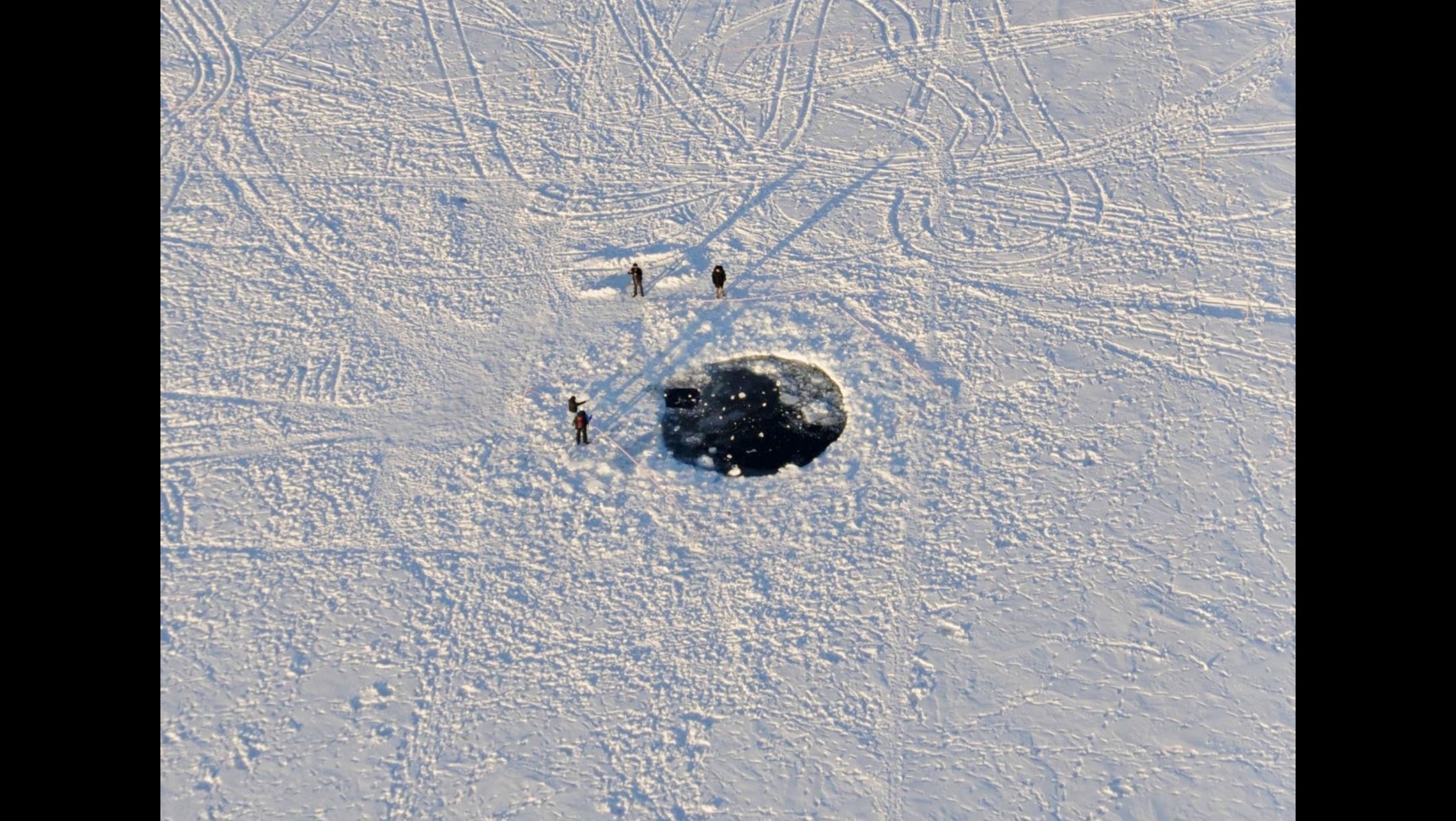 Impact site of the Chelyabinsk meteorite in the ice of Lake Chebarkul, Russia, photographed shortly after the February 15, 2013 atmospheric explosion.
