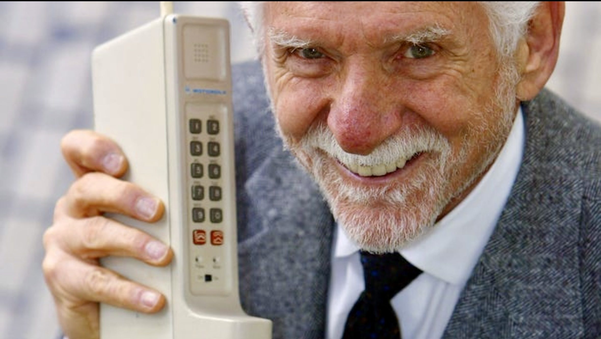 Martin Cooper holding the first mobile phone after making the first cellular phone call in 1973