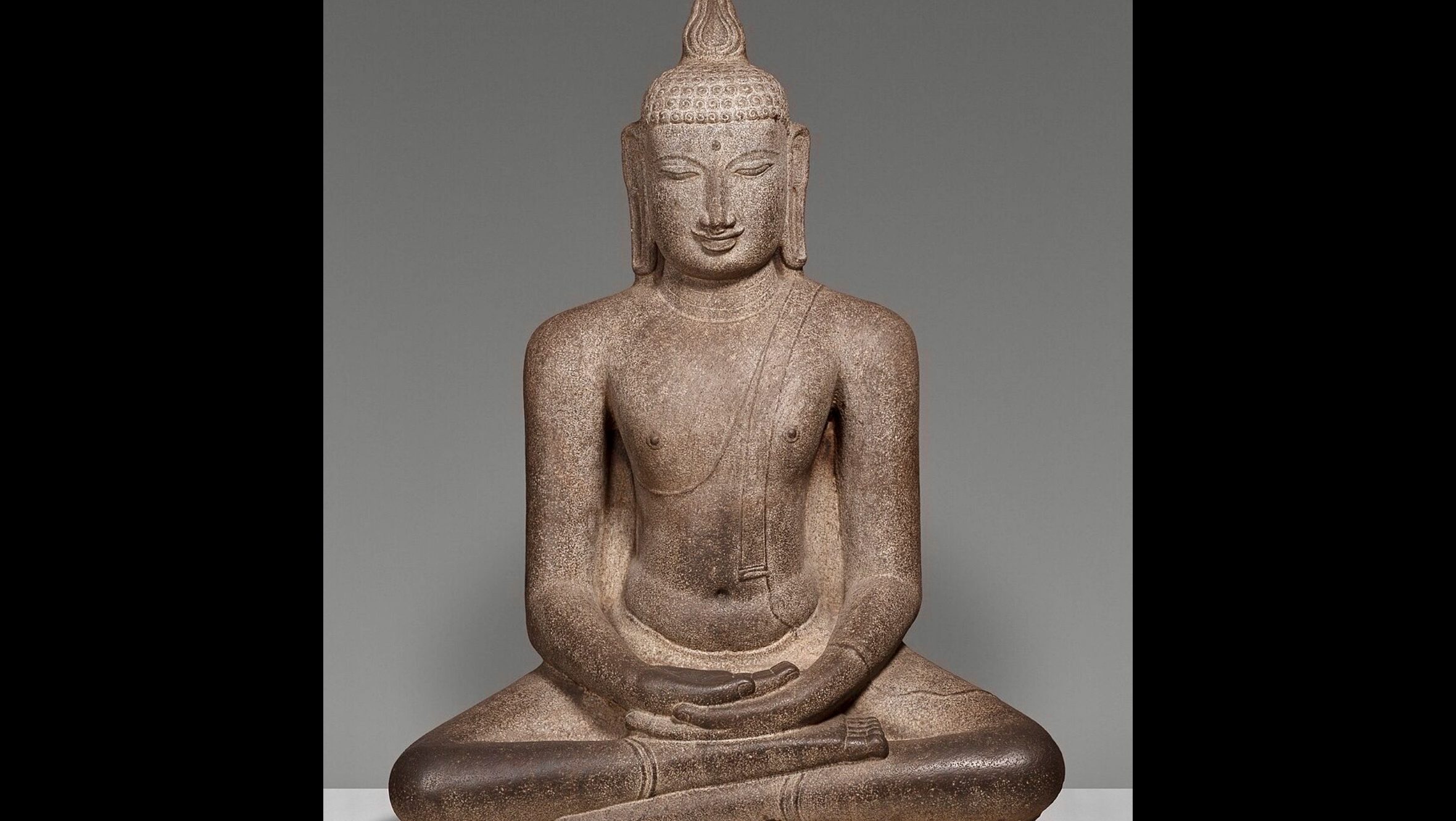 Statue of Siddhartha Gautama seated in meditation, representing the Buddha and his teachings of enlightenment.