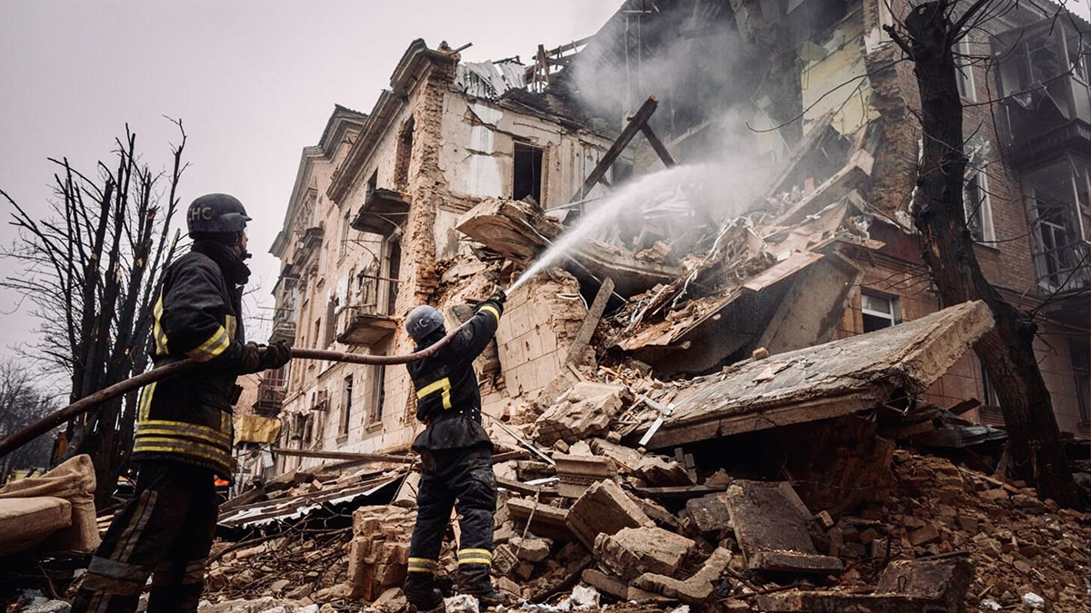 Emergency responders working among damaged buildings in a Ukrainian city following a missile strike during the ongoing war