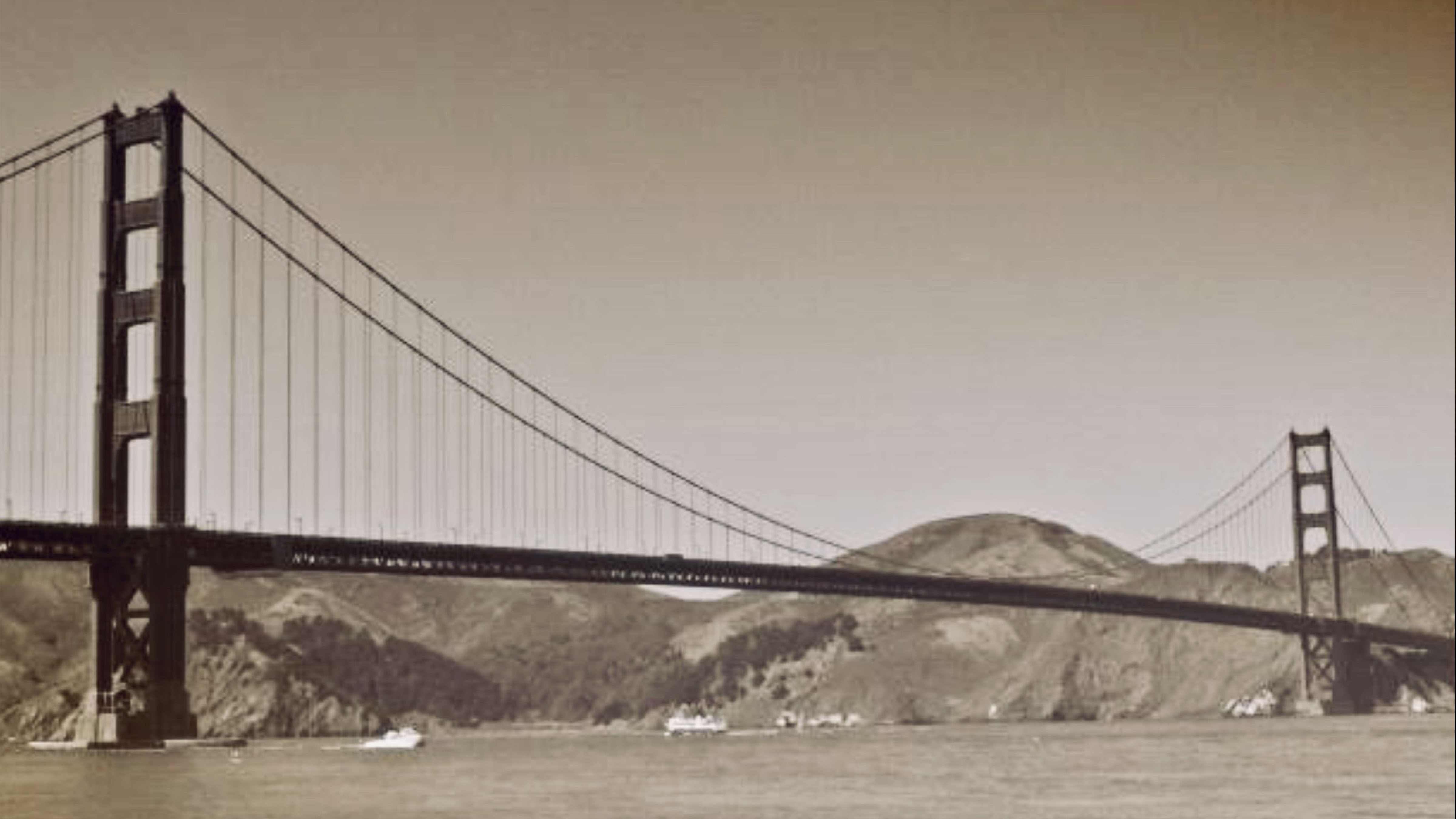 Historic photograph of the Golden Gate Bridge spanning San Francisco Bay shortly after its completion in the late 1930s.