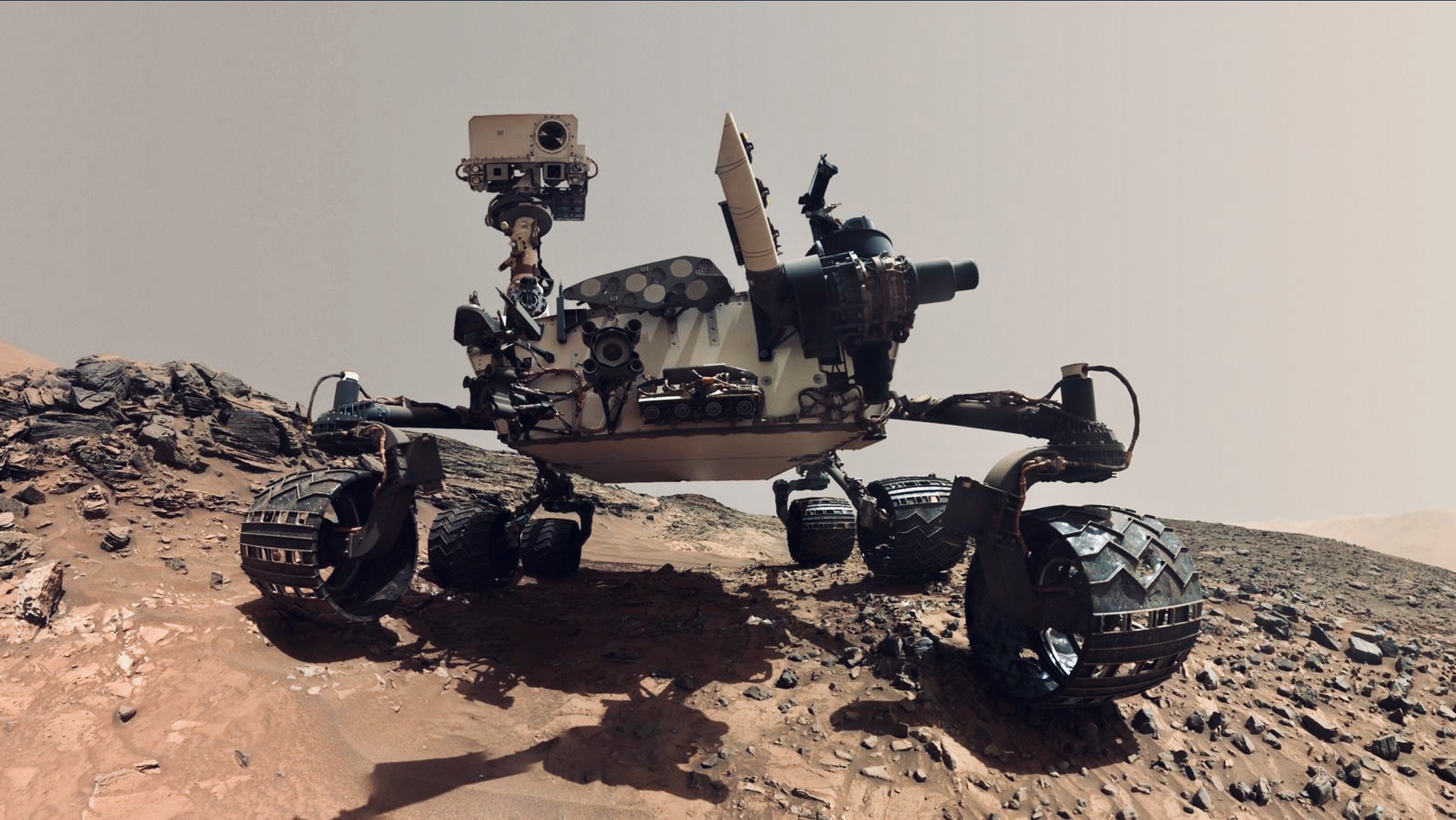 NASA Mars rover positioned on rocky Martian landscape during scientific exploration for ancient organic compounds and signs of past habitability.