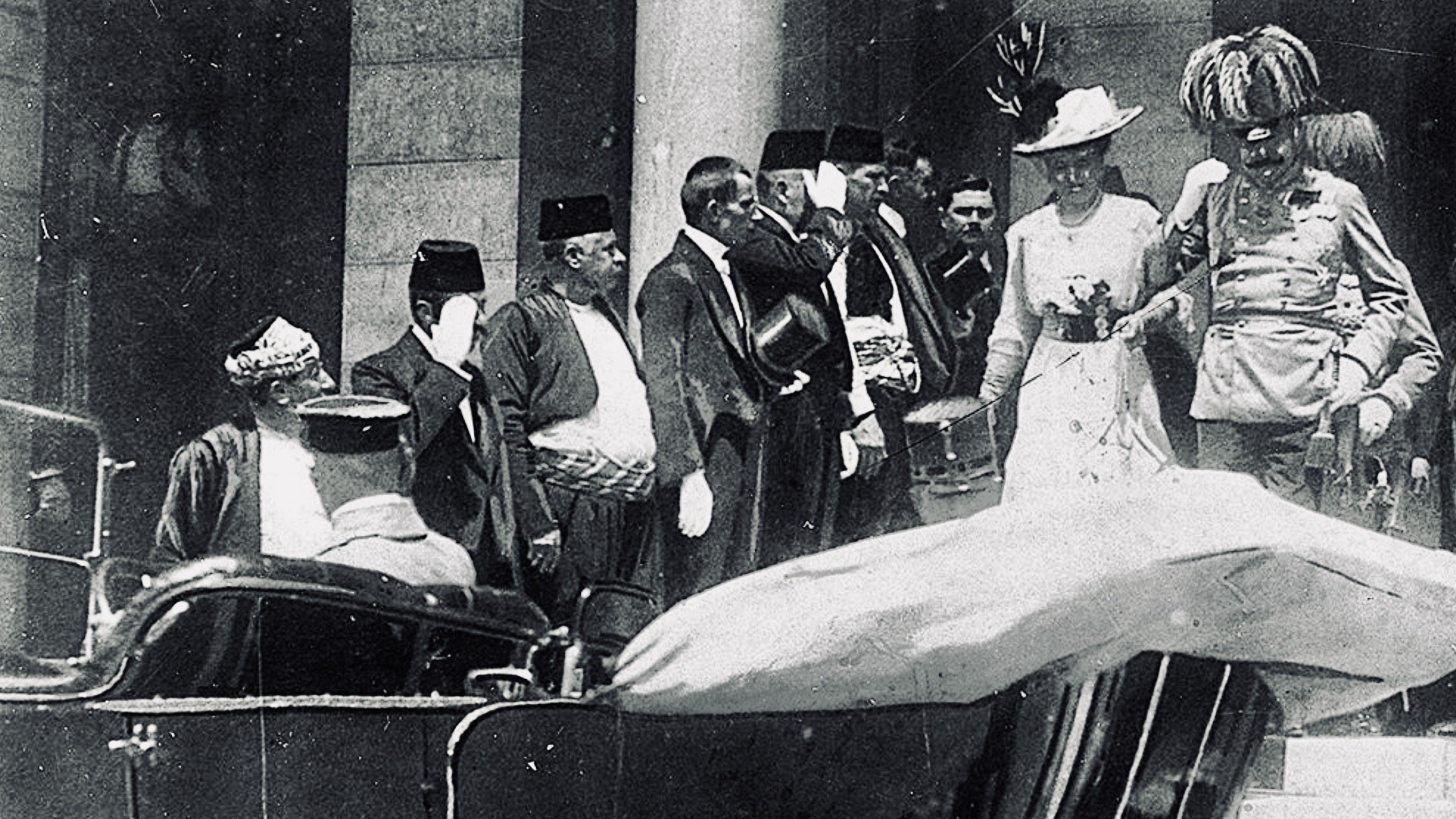 Black-and-white historical photograph showing Archduke Franz Ferdinand of Austria and his wife, Sophie, Duchess of Hohenberg, departing Sarajevo City Hall on June 28, 1914, shortly before they were assassinated.