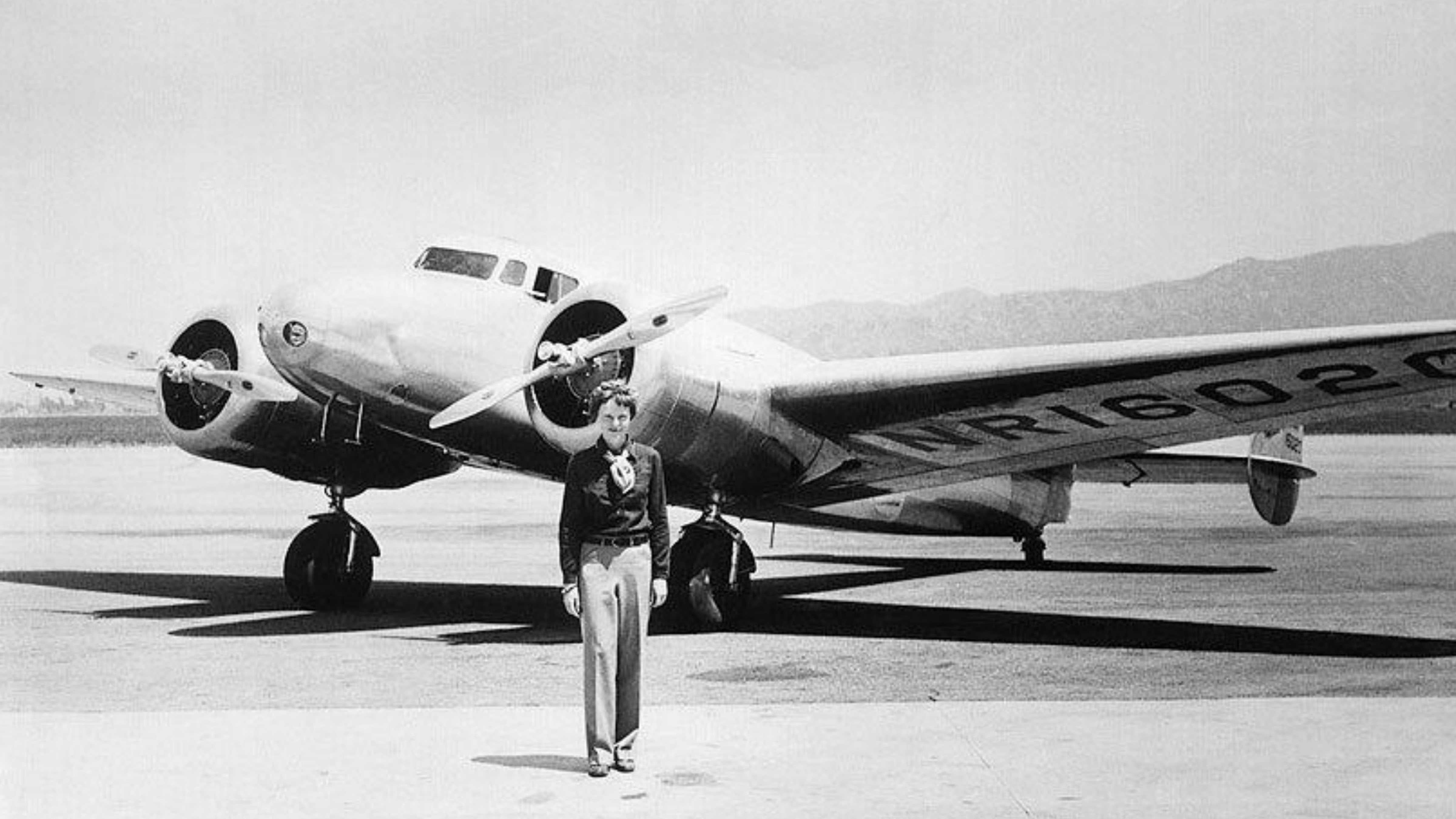 Historic photograph of Amelia Earhart standing in front of her Lockheed Model 10-E Electra (NR16020) before her 1937 attempt to fly around the world.