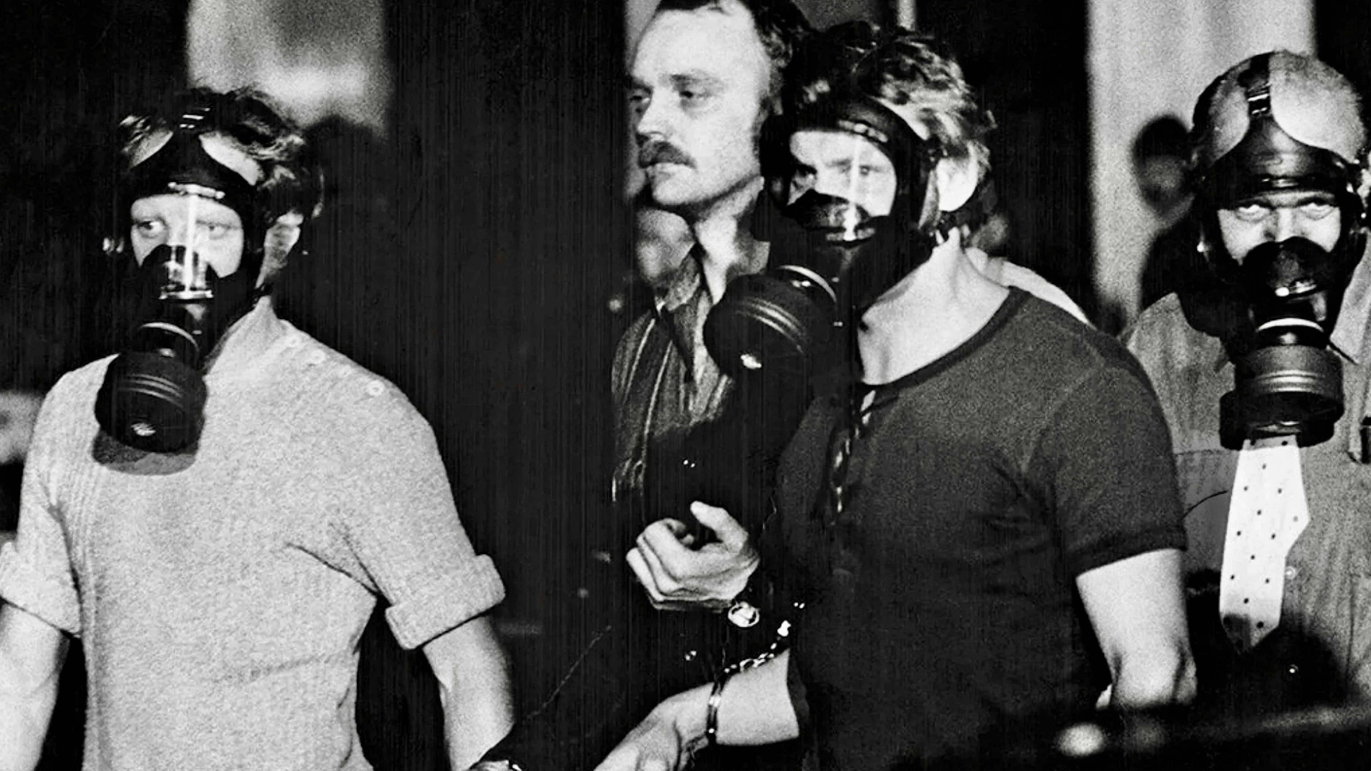 People wearing gas masks during the 1973 Stockholm hostage crisis