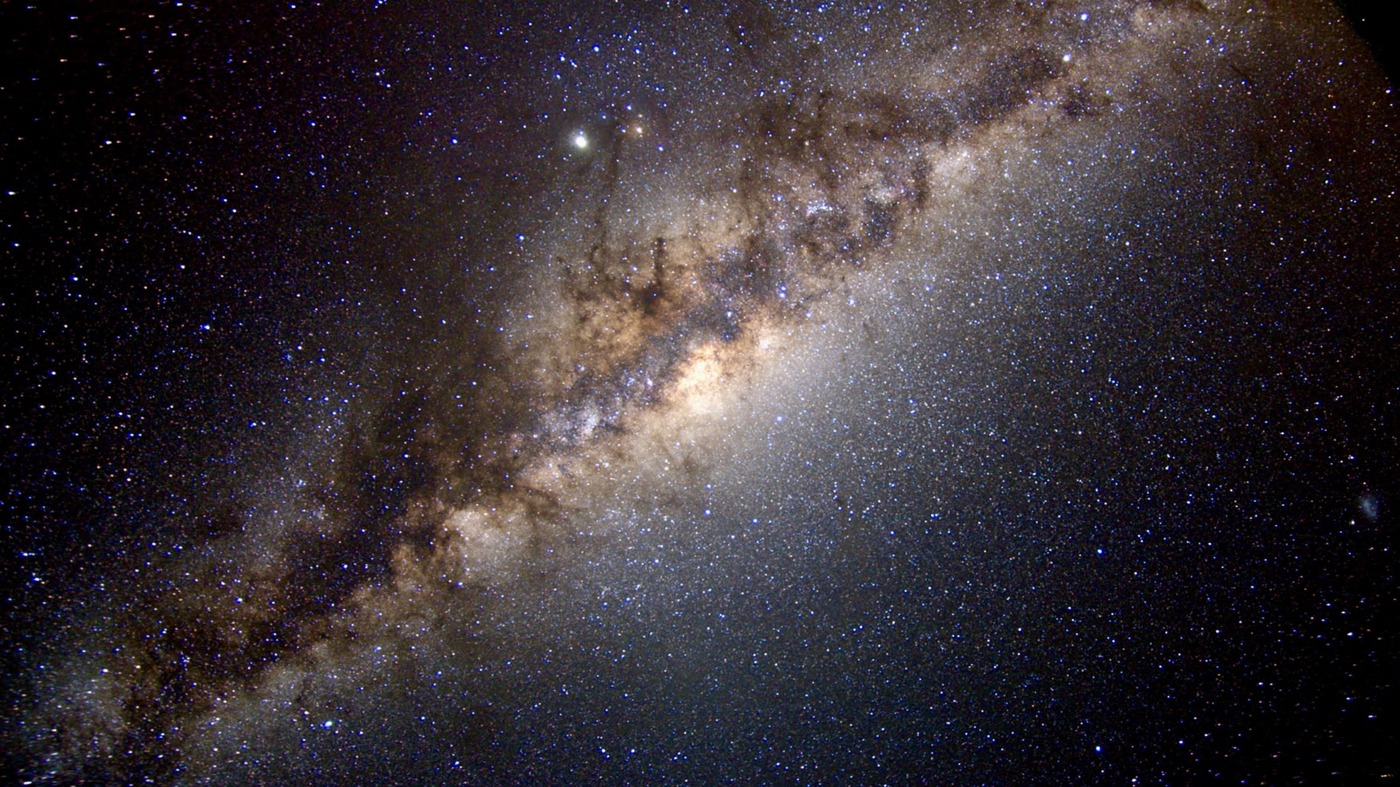 Dense star field and bright central region of the Milky Way stretching across the night sky.