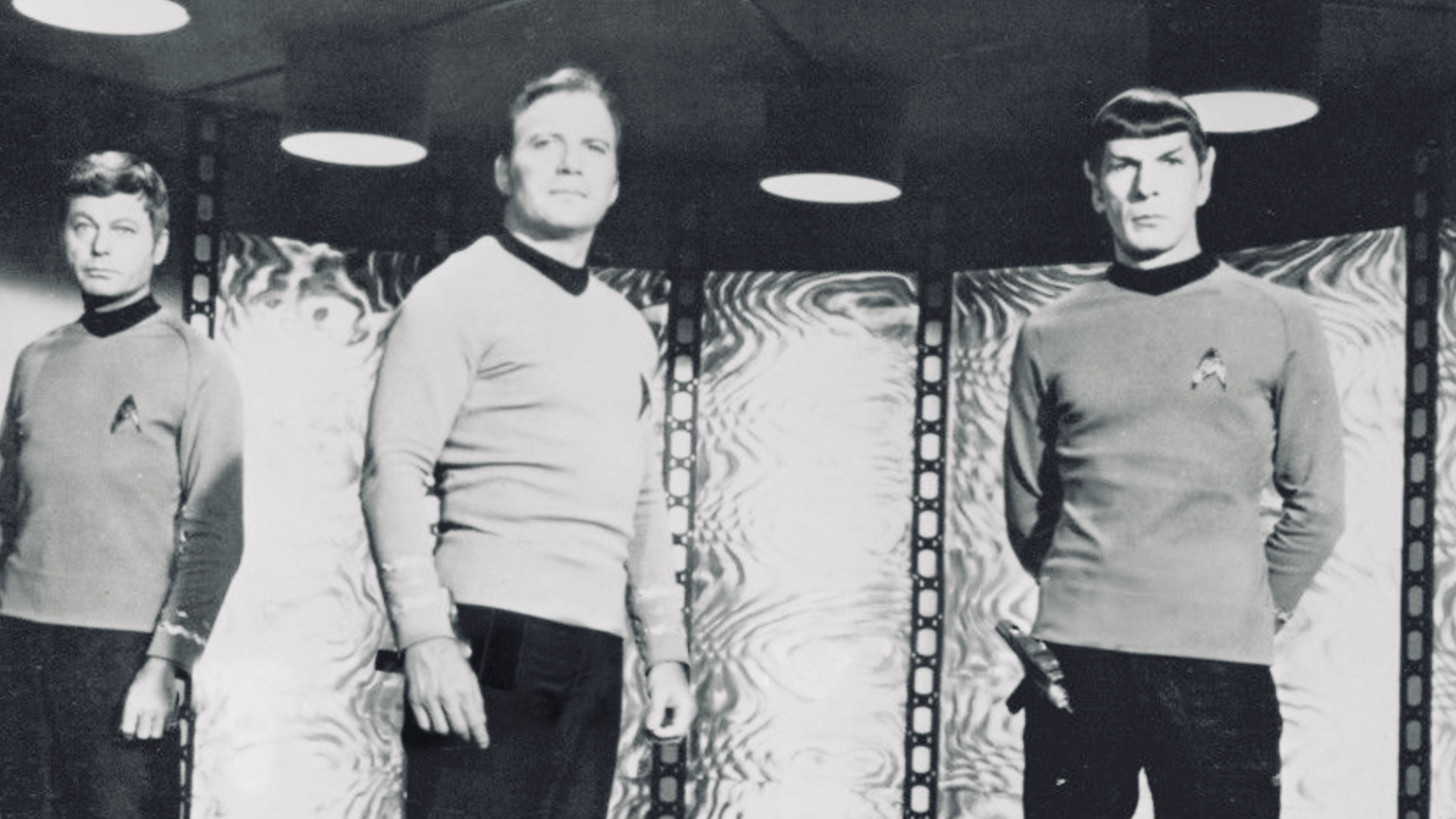 Captain Kirk, Spock and Dr. McCoy in the transporter room of the original Star Trek television series.
